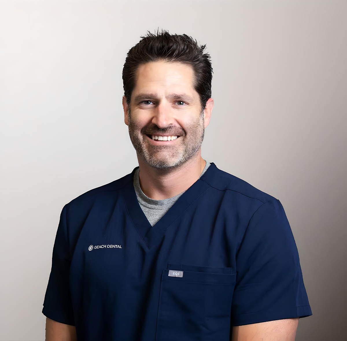 Dr. Adam J. Geach examining dental restorations in laboratory