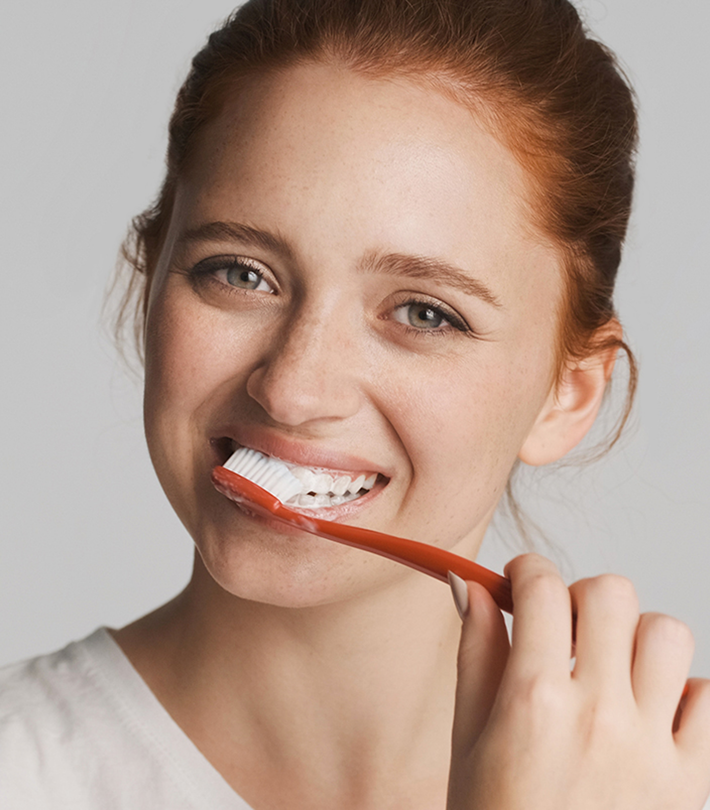Smiling girl brushing teeth - Periodontal Therapy at Geach Dental